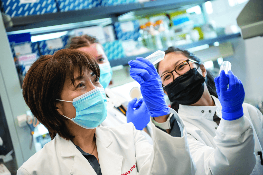 Professor Jiyoung Lee and graduate students in her water quality testing lab in the College of Public Health.